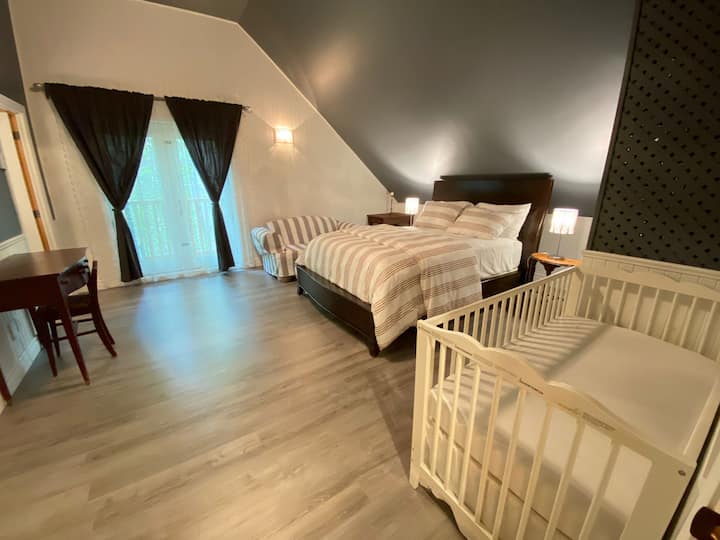 The upstairs bedroom offers ample space and privacy, ideal for relaxation. The attached private bathroom is equipped with modern fixtures, including a  toilet, and sink. It provides convenience and privacy for guests.