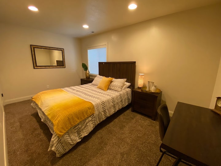 Queen bedroom with adjustable base, walk in closet, desk space, wall-mounted TV