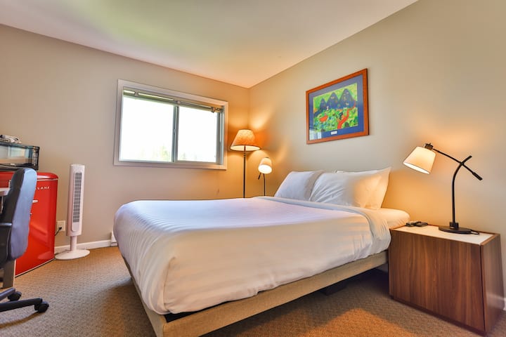 hotel-style lock-off room with a brand-new Queen bed and ensuite bathroom