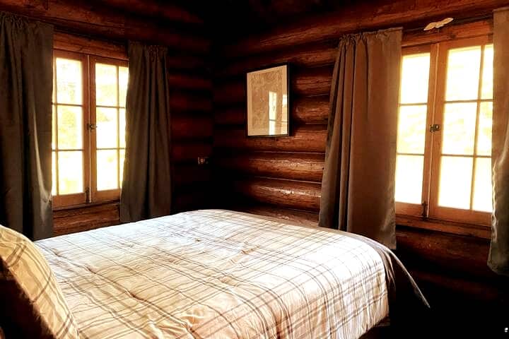 Bedroom facing Wolf Pond. It might be a small room that we crammed a Queen bed into but nothing beats waking up, laying in bed and enjoying the view of the pond and mountains! 