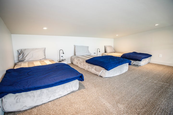 The sleeping loft accessed by a custom ship ladder offers three twin beds. 