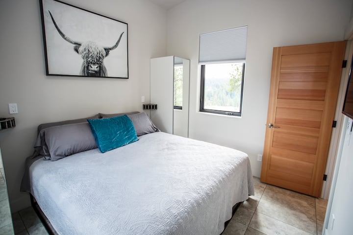 Bedroom on the main floor outfitted with a king bed