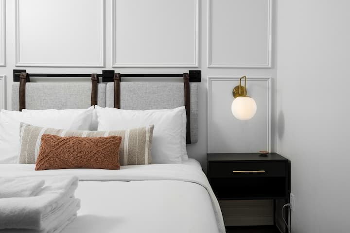 1st floor bedroom with queen bed and custom wall treatment. 