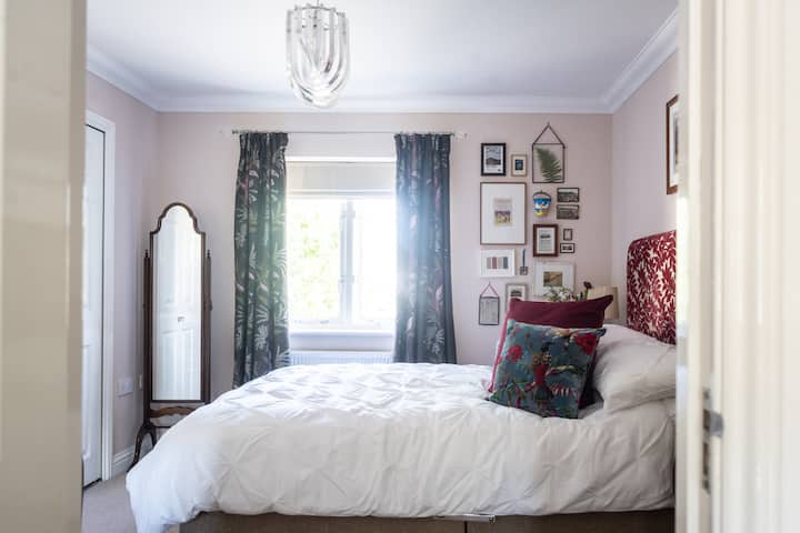 Comodo letto matrimoniale con 4 cuscini e cuscini.
Non vedenti romani oscuranti.
Specchio a figura intera con presa di corrente accanto.

Foto: clairenaylorphotography.co.uk