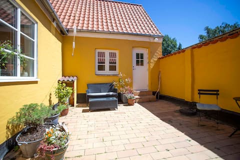 Small house with courtyard, close to forest and beach.