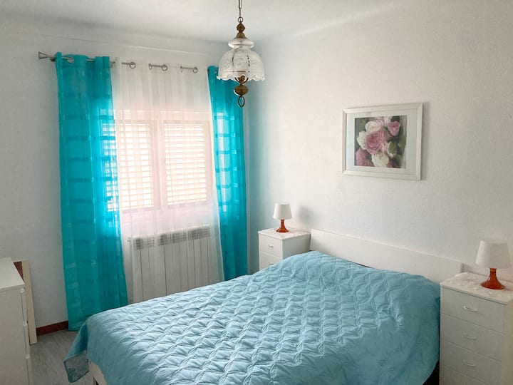 Bedroom 1, with a double bed, dresser and wardrobe (1st floor).