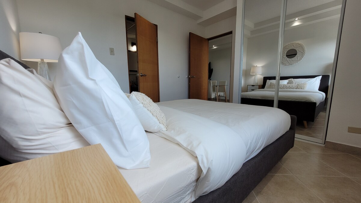 Alternate view of the bedroom to appreciate the compact closet and the door to the bathroom that is located in the bedroom.