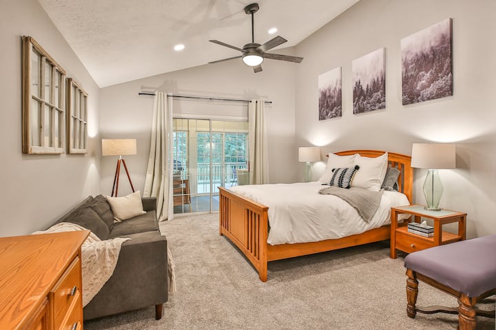 Bedroom #2 includes a queen bed, cb2 couch, dresser and an en-suite bathroom.  The sliding glass door opens to the home's sunporch.