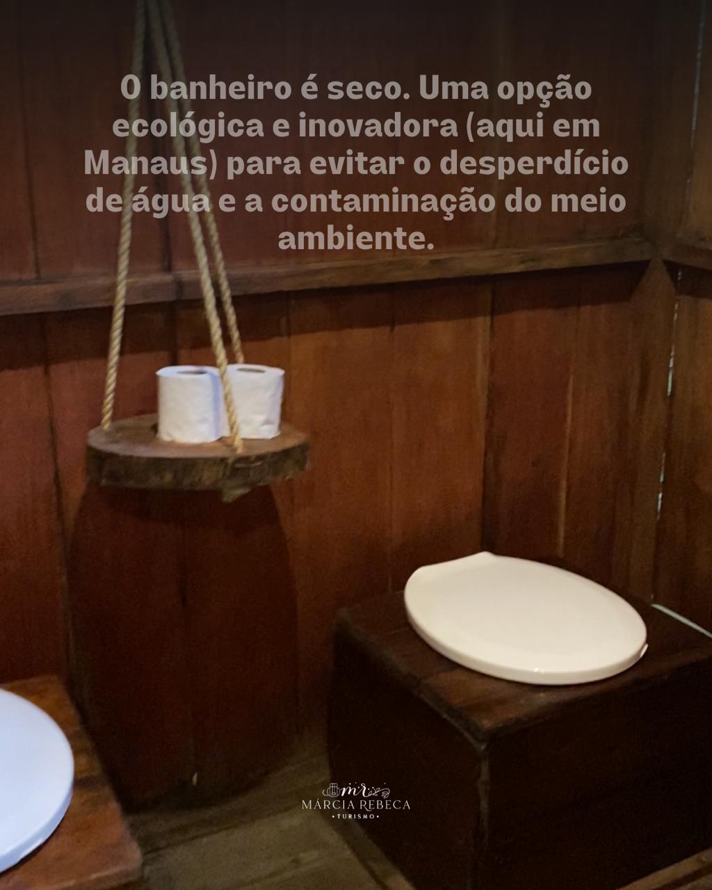 A dry ecological toilet is presented in a wooden interior. Two rolls of toilet paper are placed on a hanging wooden holder beside the toilet. The design aims to minimize water waste and environmental contamination.