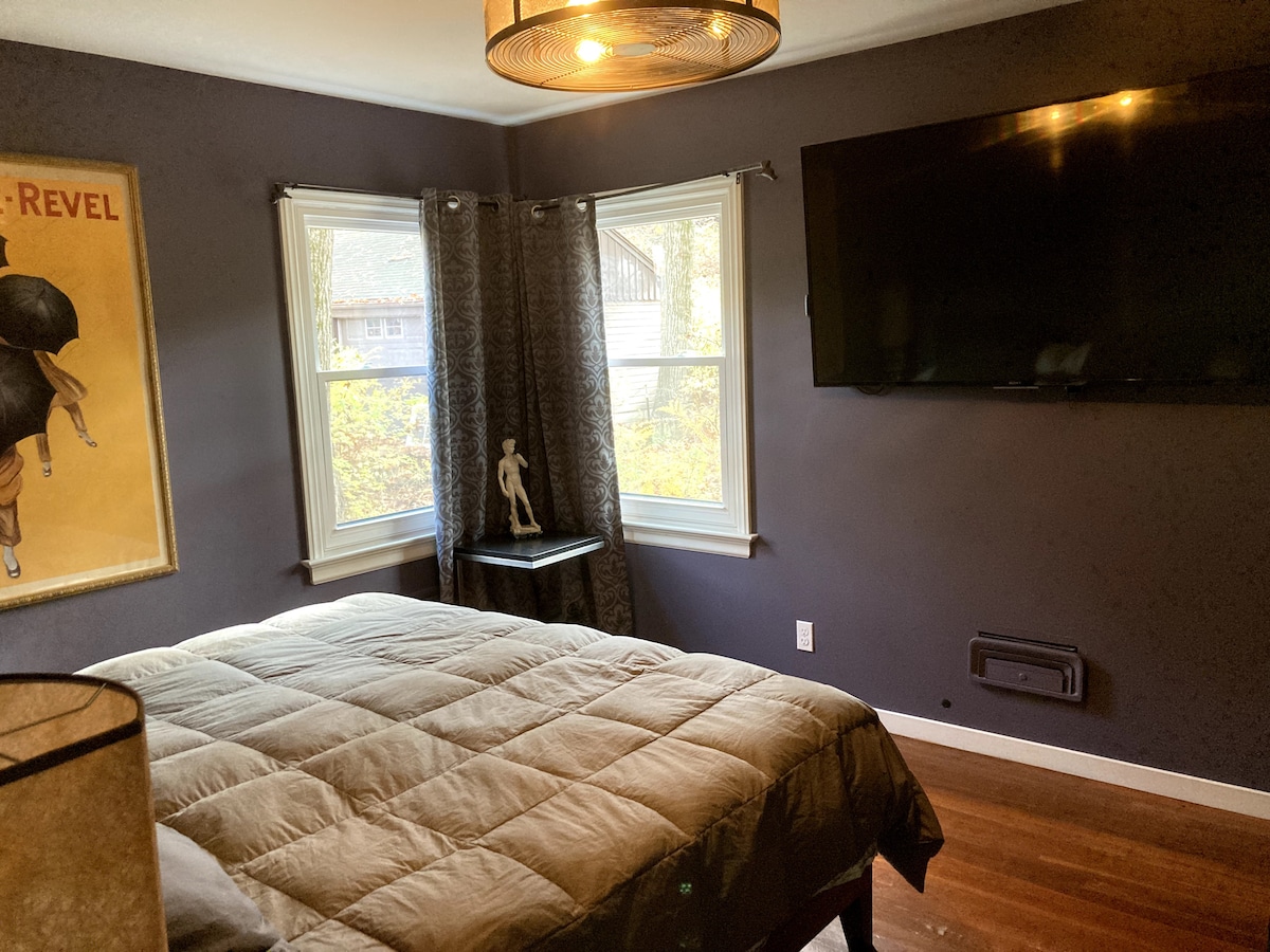 King bedroom with a  65" television and a view 