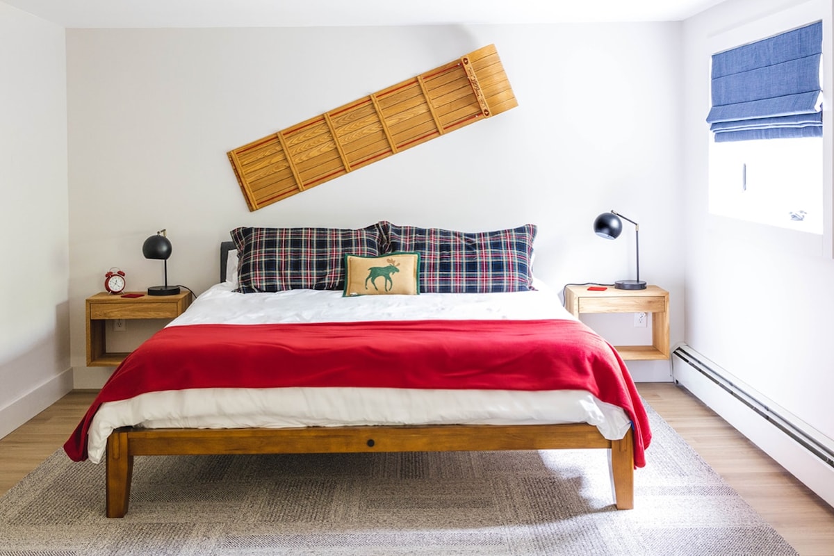 Get a great night's sleep in this king-size Thuma bed on the basement level. (It's a walk-out basement with a picture window and sliding glass door looking out on the private wooded backyard!)

photo by Layla Wolfberg