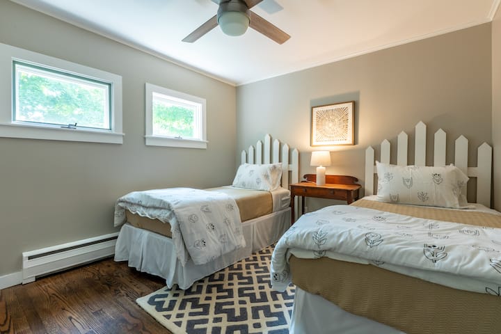 Twin beds and again shades were installed after the photos were taken.