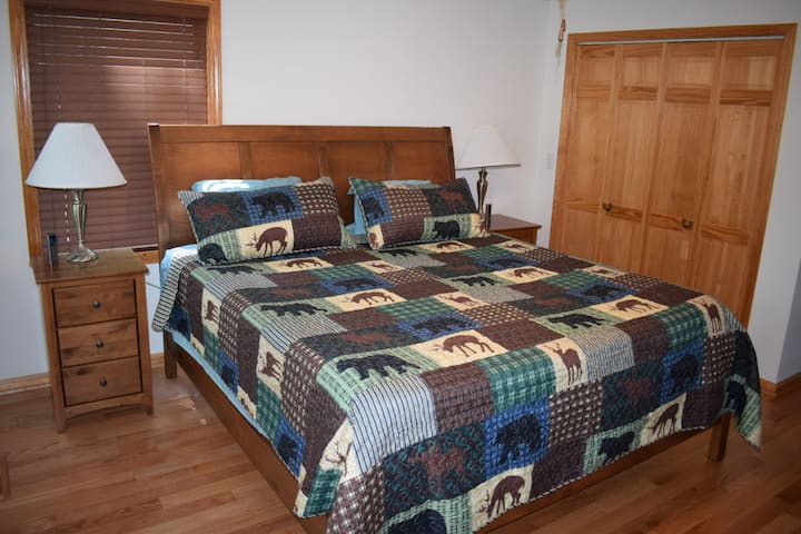 MASTER BEDROOM
King sleep number bed w/ remotes,  ceiling fan, nightstands, closet with hangers, dresser for clothes,  box fan, and 55" Smart TV. 