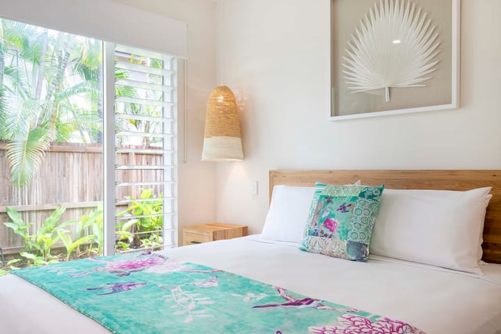 تفتح غرفة النوم الرئيسية على حديقة خاصة وحمام سباحة للسباحة في الصباح الباكر.