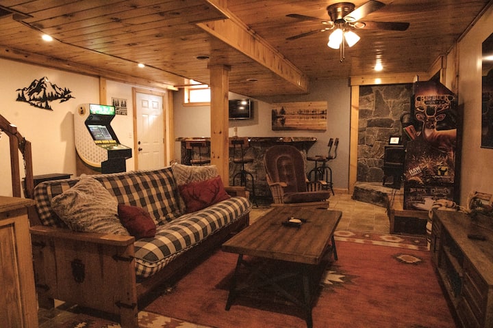 Basement bar room with arcade games, board games, dart board, and N64. 