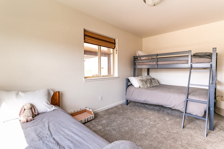 Bunk room at Blair Bungalow—bunk bed plus trundle sleeps 3. Family-friendly Fruita, CO vacation rental near 18 Road and Colorado National Monument. Pack-n-play and toddler gear available.