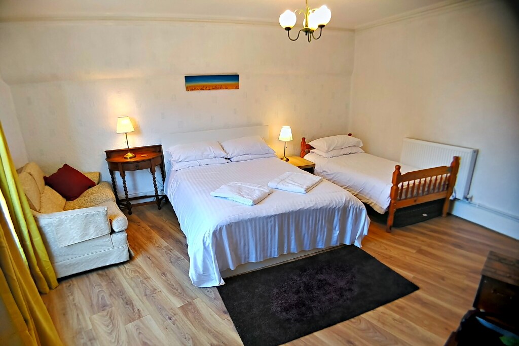 1st floor bedroom. Kingsized bed with extra single and still enough room to swing a cat.  Freestanding wardrobe with drawers and ornate (non-functioning) fireplace