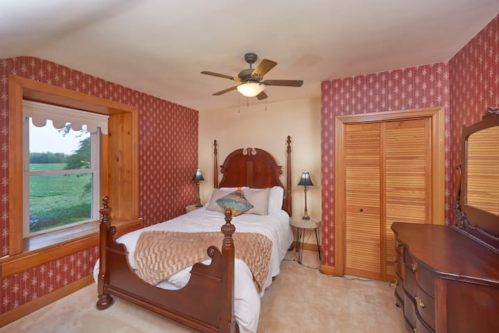 Large Queen Bed with a view of the farm fields. 