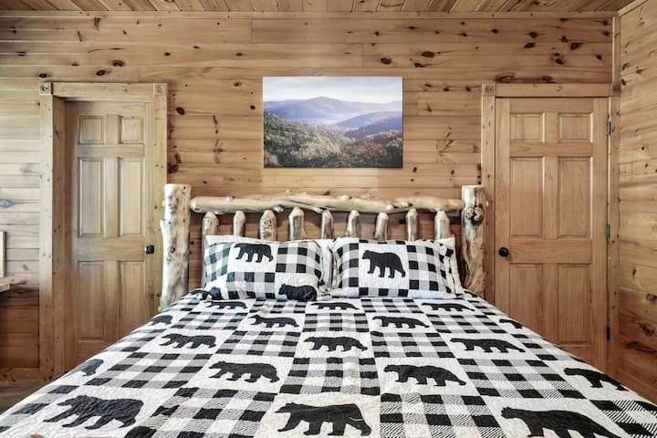 Downstairs bedroom. King Size bed. Door on the right leads to the kitchen area. Door on the left leads to the downstairs bathroom