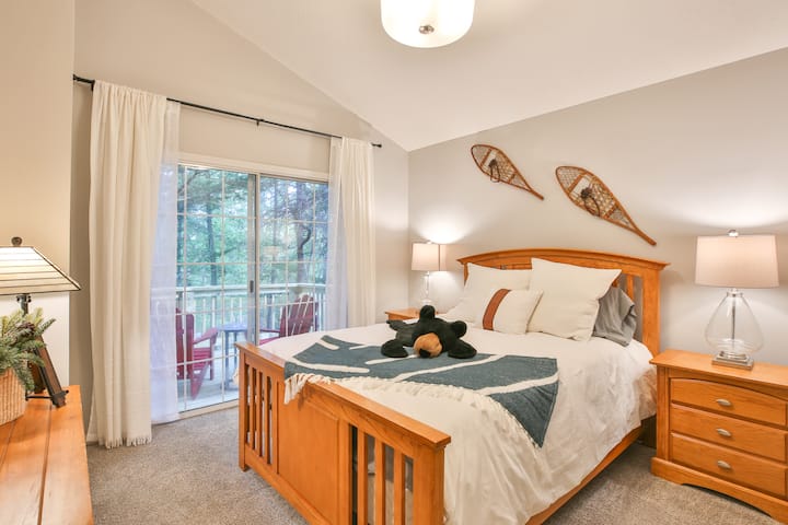 Bedroom #3 features a queen bed and sliding glass doors that open to an alcove deck off the main deck.