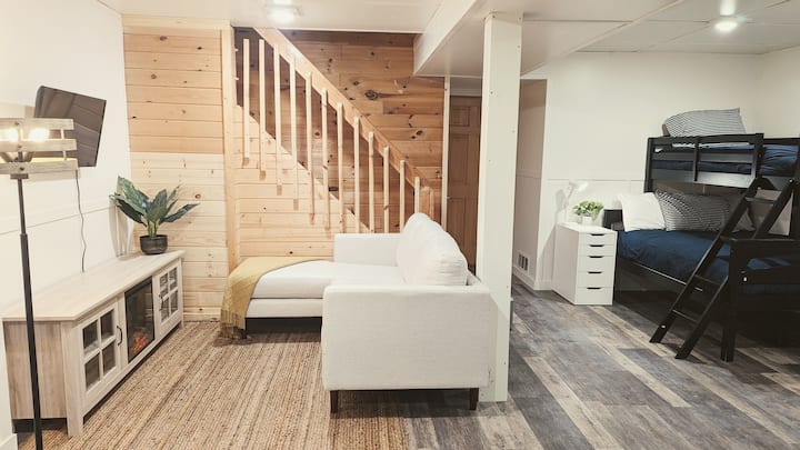 Lowest level now open! This additional space includes a second living area, a bunk bed, a bathroom/laundry area, and two arcade games for your enjoyment. 