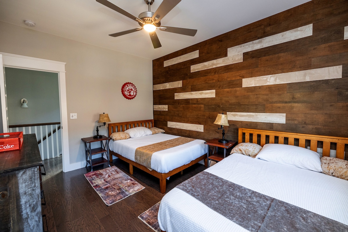 The charismatic third bedroom has two full sized beds, full dresser, distressed wood planks, original art by Glen and even an old fashioned Coke crate. And don't forget the whimsical rustic lamps that contain USB ports to charge your electronics.