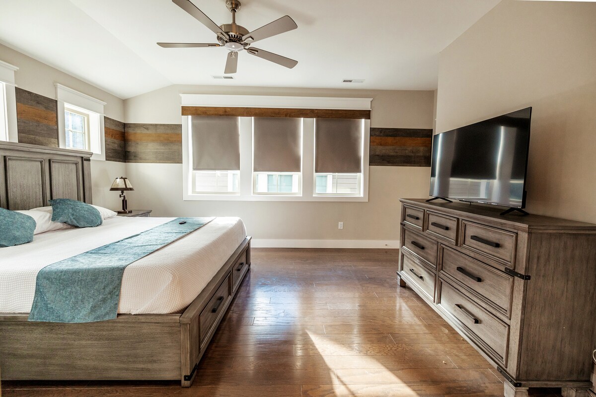 The roomy and handsomely adorned Primary bedroom represents the perfect room to end your glorious day in. Watch your favorite show/movie on the 50" Smart TV. You'll have easy access to the in-suite luxurious bathroom as well as the walk-in closet.