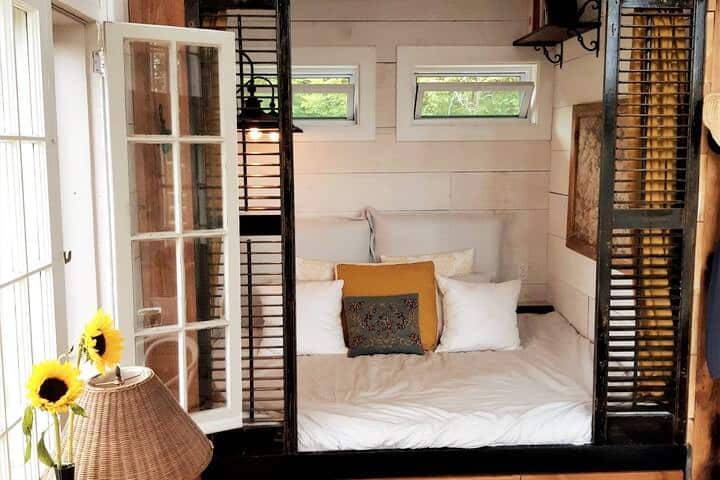 A Scandinavian Box bed with a queen mattress, an all natural  
 wool duvet wrapped in linen is the most cozy sleeping arrangement.Wake up to the sunrise or curl up with one of the many books from the library or nap after hiking the 88 acre property.