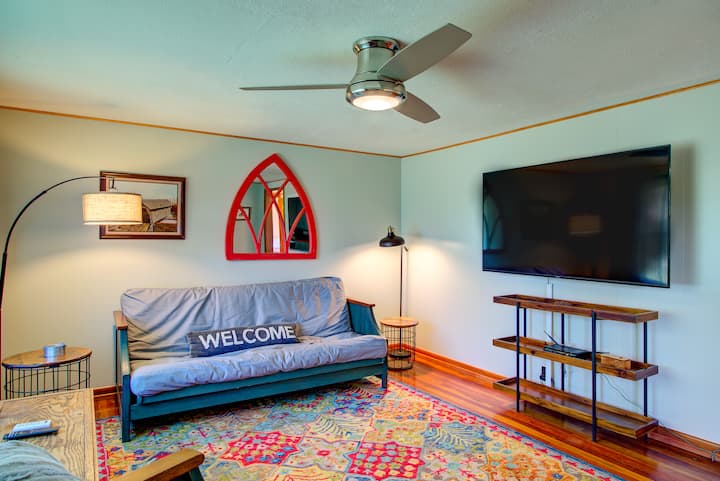 Cozy well lit living room with a futon and large screen TV for with streaming apps available!