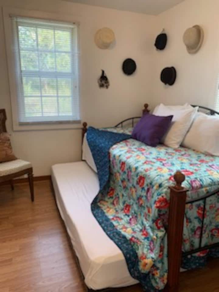 Main level bedroom with twin day bed and trundle. 