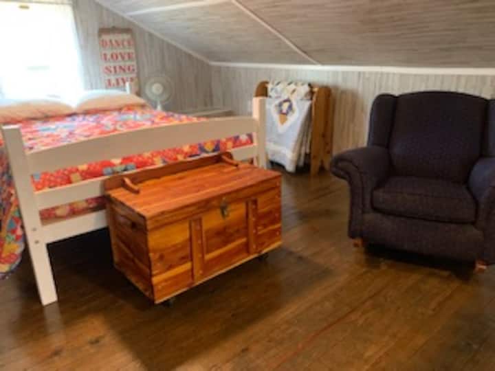 Second floor bedroom with sleeping for three in one full size and one twin size bed. The second floor features window seating. 