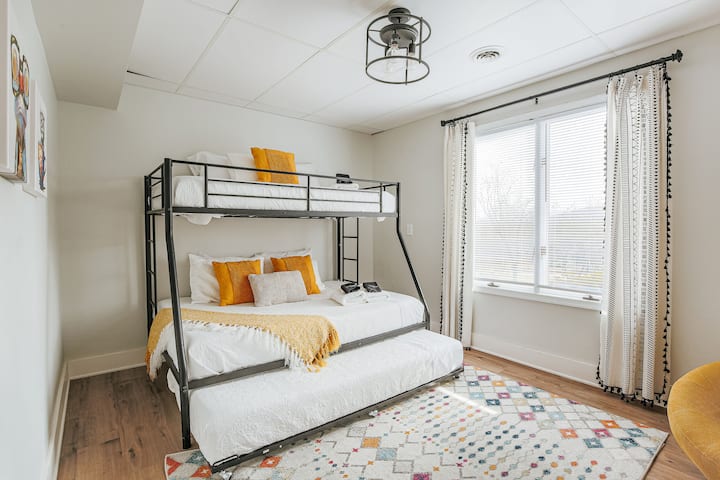Downstairs bunk bedroom with a twin on top, full on bottom, and trundel twin below