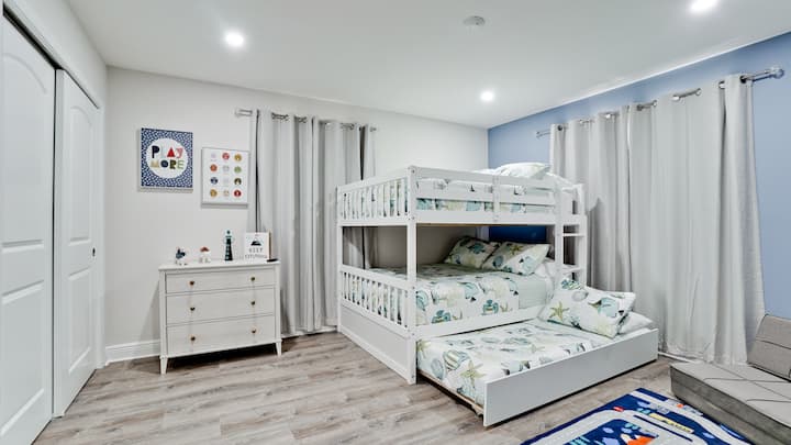 A charming and comfortable haven for the younger ones, featuring whimsical decor and plenty of sleeping options.
Kids room with a bunk bed and a pullout and a 50" smart tv.
