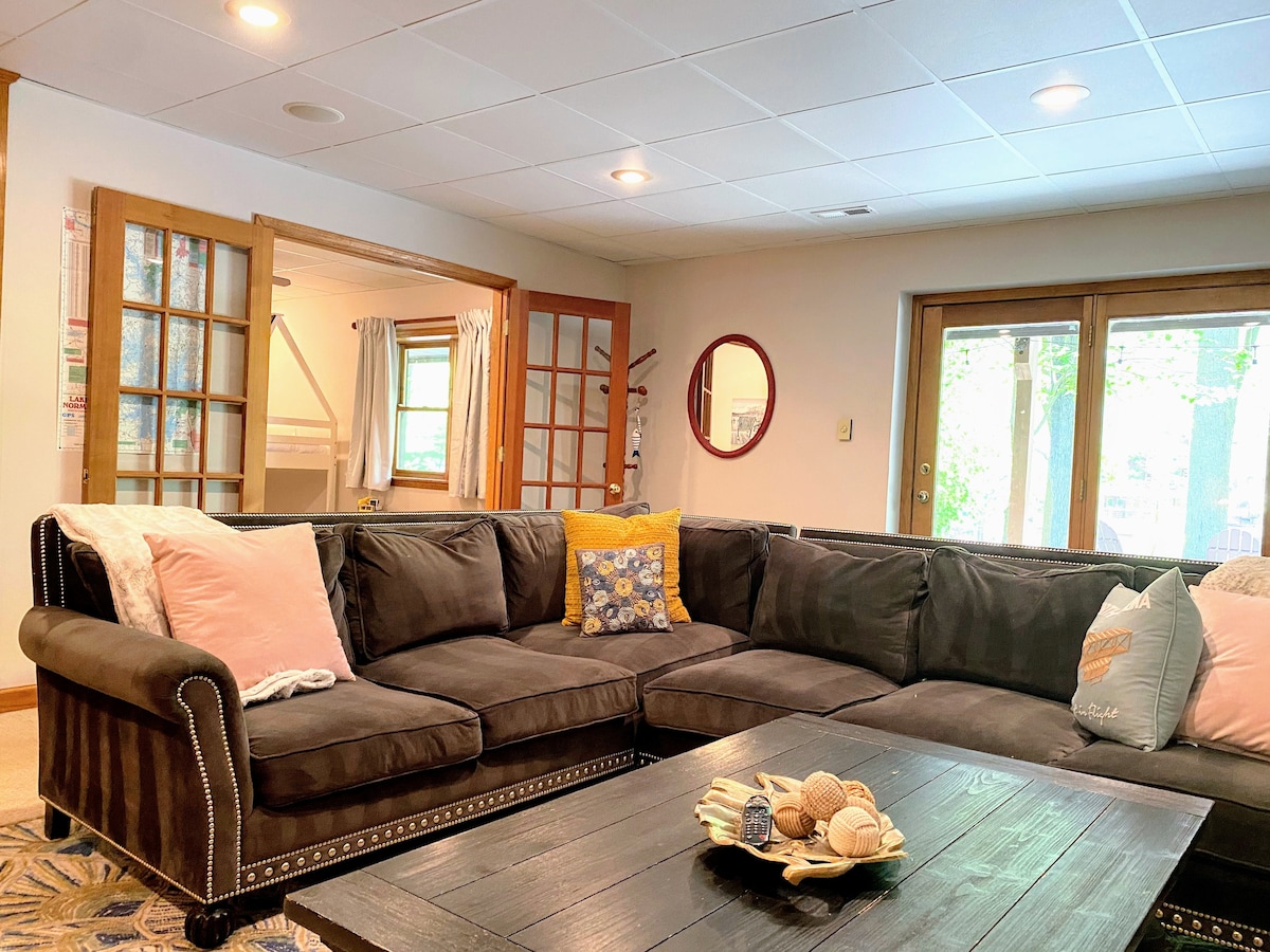 Basement gathering space in front of 75" smart TV. Move night never looked so good.