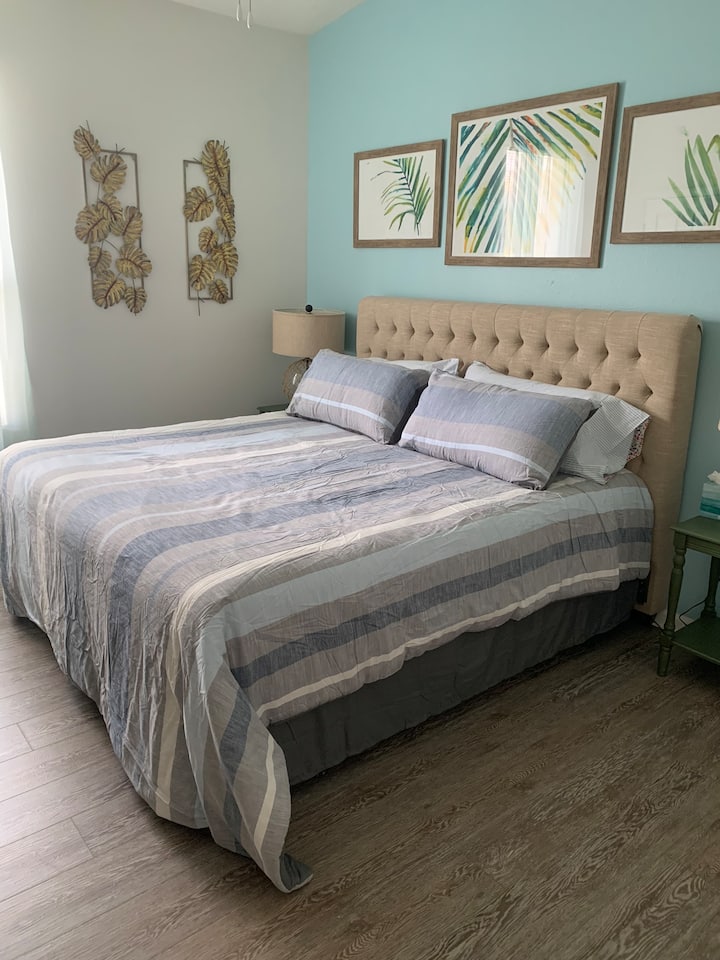 Master Bedroom 2 with king bed, luxury vinyl flooring, TV and private bathroom