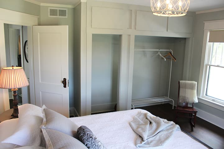 The primary bedroom has a large closet, rocking chair and luggage rack.