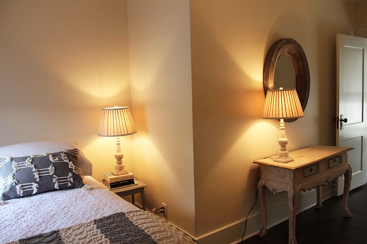 Secondary bedroom with  2 twin beds features bedside reading.