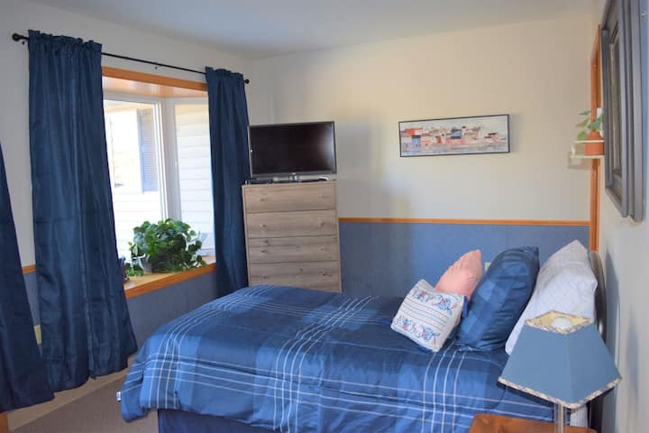 Home Sweet Home.  (room 10, twin) This fun room has a patio door that leads out onto a private deck!  It's one of two bedrooms in the south wing.  It has a half bath, dresser, and TV.  (No closet)  The dedicated workspace is right outside your door.