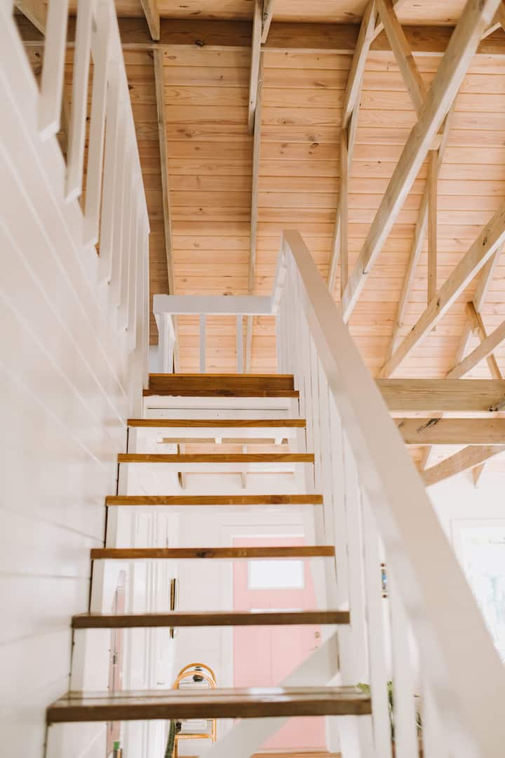Stairs leading to the loft in Cocomo Cottage  - a luxury vacation rental near Gregory Town in Eleuthera, Bahamas.