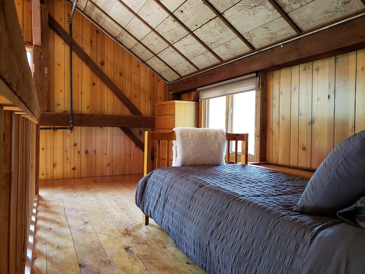 Each of the smaller loft bedrooms include a twin bed, dresser, and bedside table.