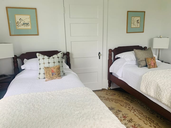 The Twin bedroom is sweet and bright with quite the view too! Decorated with well-curated pillows, locally hand-stitched bed quilts and and English knot rug, it is one of our favorite corners of the house. All rooms have extra pillows and covers.