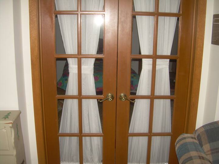 French doors between bedroom and walk-out area.