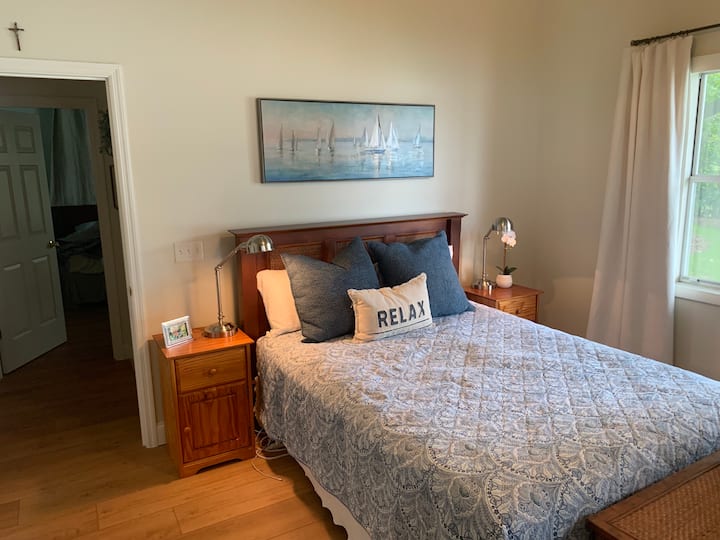 Primary bedroom with sliding doors into the screen porch