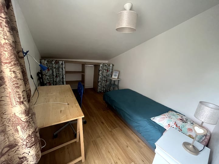 Chambre au 1er étage équipée d'un lit simple 90x200 cm et d'un espace de rangement. Coin bureau. Accès internet en filaire et en WiFi.