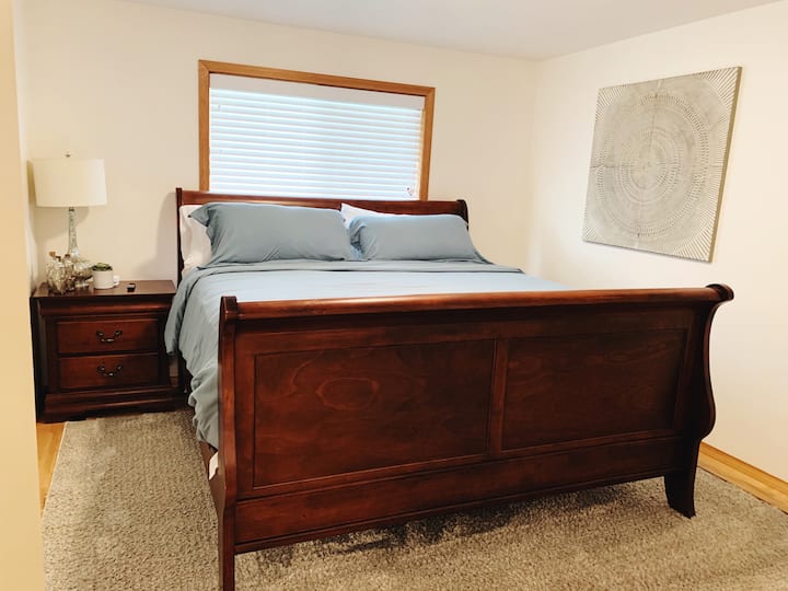 Main bedroom with king sized sleigh bed and smart TV. Hooks for all your bath and lake towels.