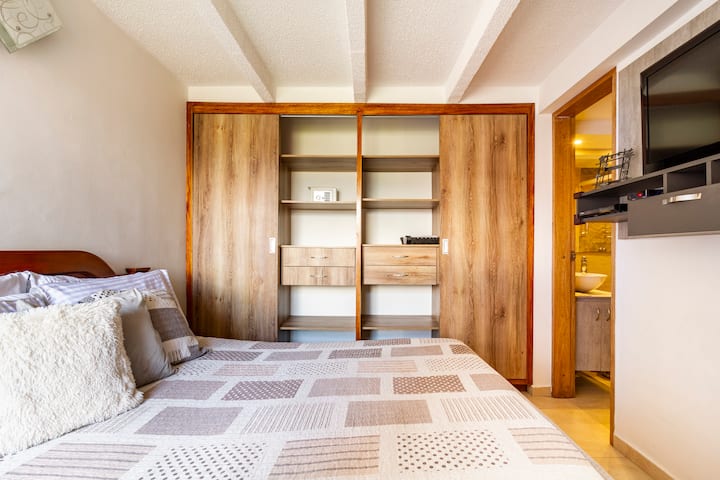 Main bedroom with double bed, private bathroom,bathtub ,tv,spacious closet and a beautiful view!
