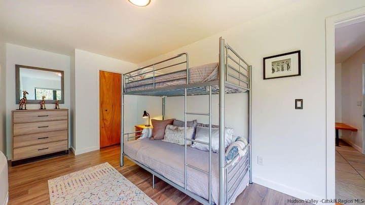 Middle level bunk room.  Many windows that look out on the perfectly flat back yard.