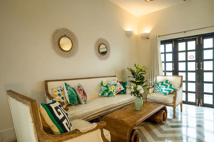Spacious living room with Air conditioning right where you can enter through the pool door and dive in the private pool