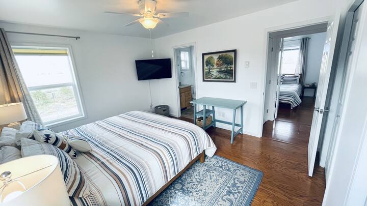 Master bedroom with Ensuite Bathroom.  Comfortable king size Serta mattress, Pendleton comforters, high thread count sheets, and plush pillows. With a Smart TV to watch your favorite streaming services.