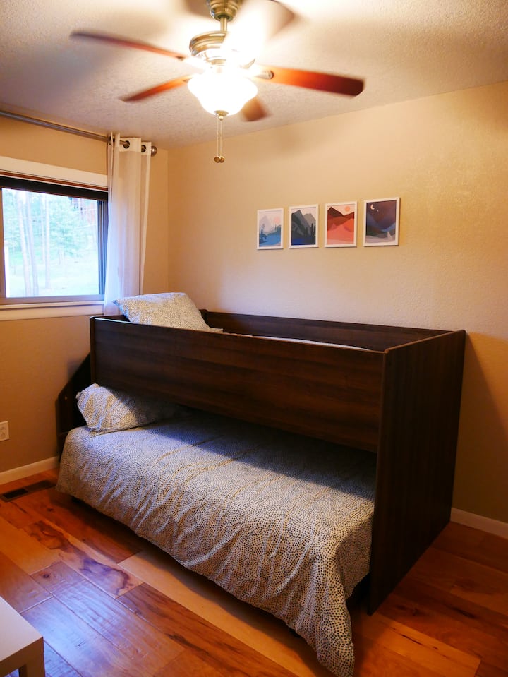 Удобни двойни двуетажни легла с разтегателно долно легло. Вградените стълби са пълни с книги и играчки за деца. Обърнете внимание: тази стая е проход към основната спалня с врата между всяка стая за уединение. 